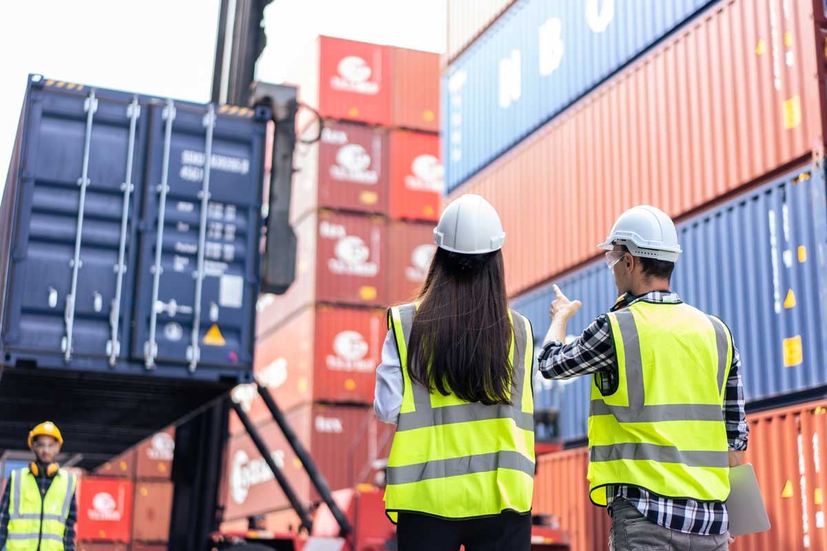 terminal employees checking containers in the container terminal reviewing compliance laws